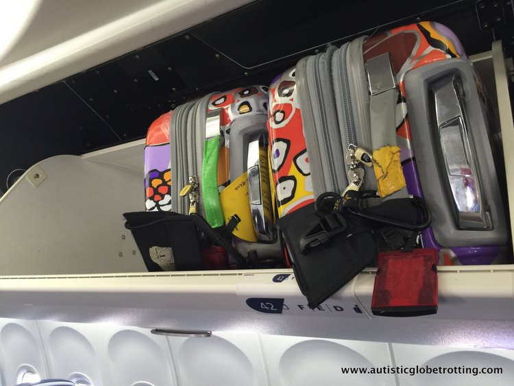 Airline Safety Tips to Practice with Kids suitcases in overhead bins on united