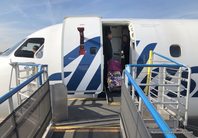 Alaska Airlines Exceeds Expectations Despite a 2 Hour Delay crew helps with carry on
